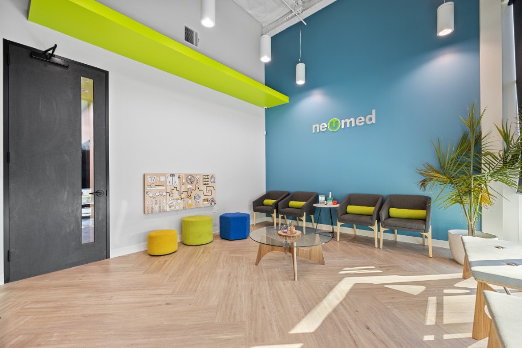 NeuMed clinic waiting room with modern teal and green interior